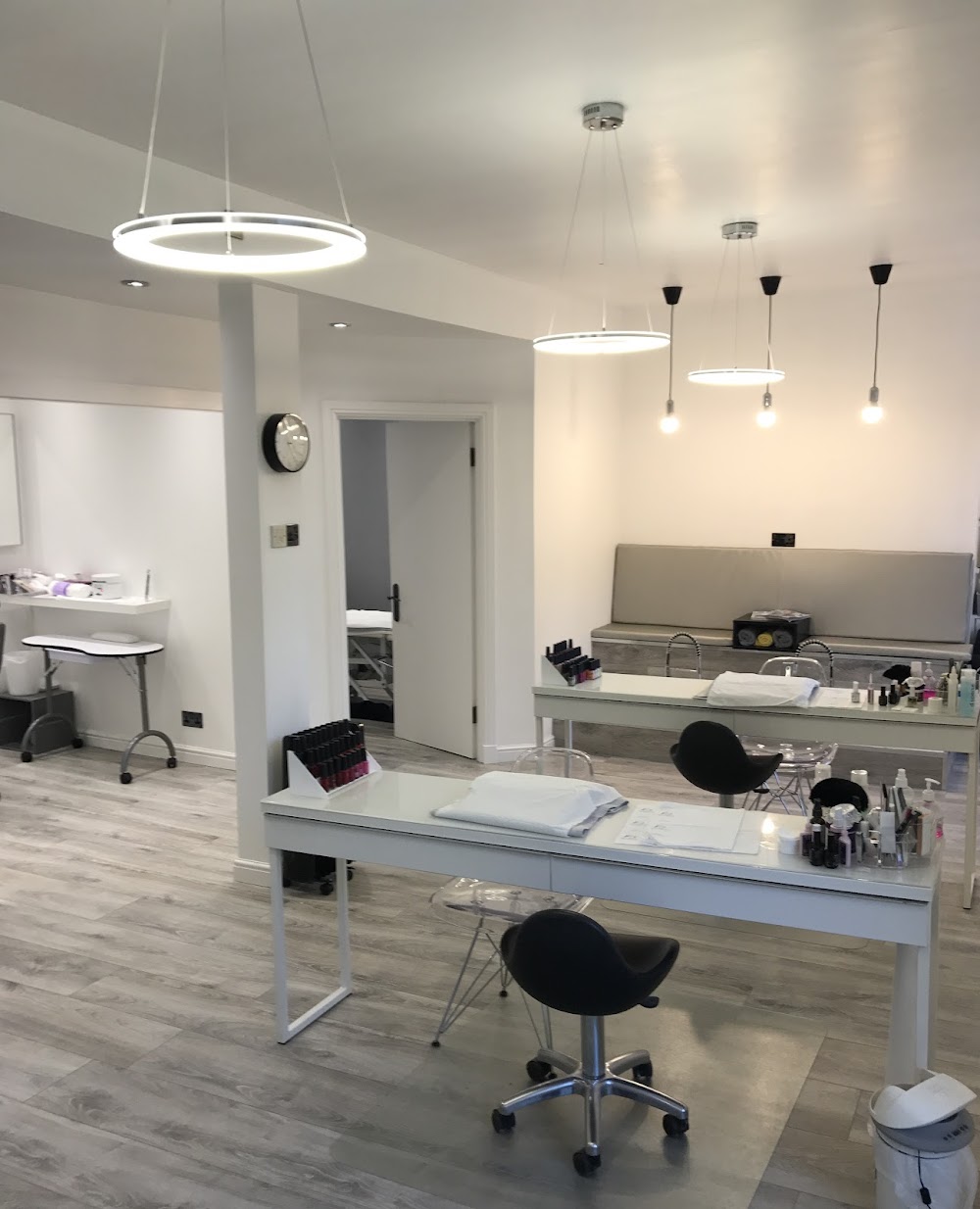 Bright beauty room with manicure stations, ring lights and modern salon fittings