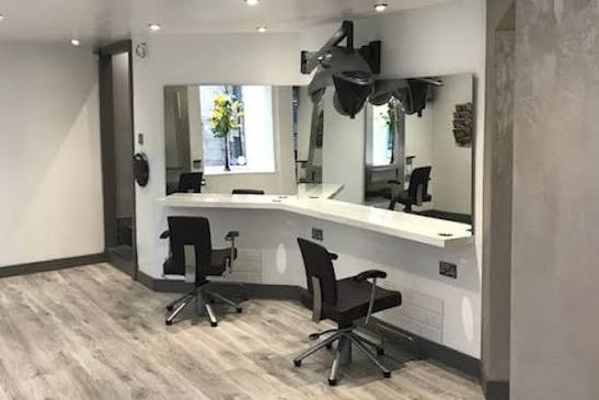 Styling stations with mirrors and chairs inside the Edinburgh salon